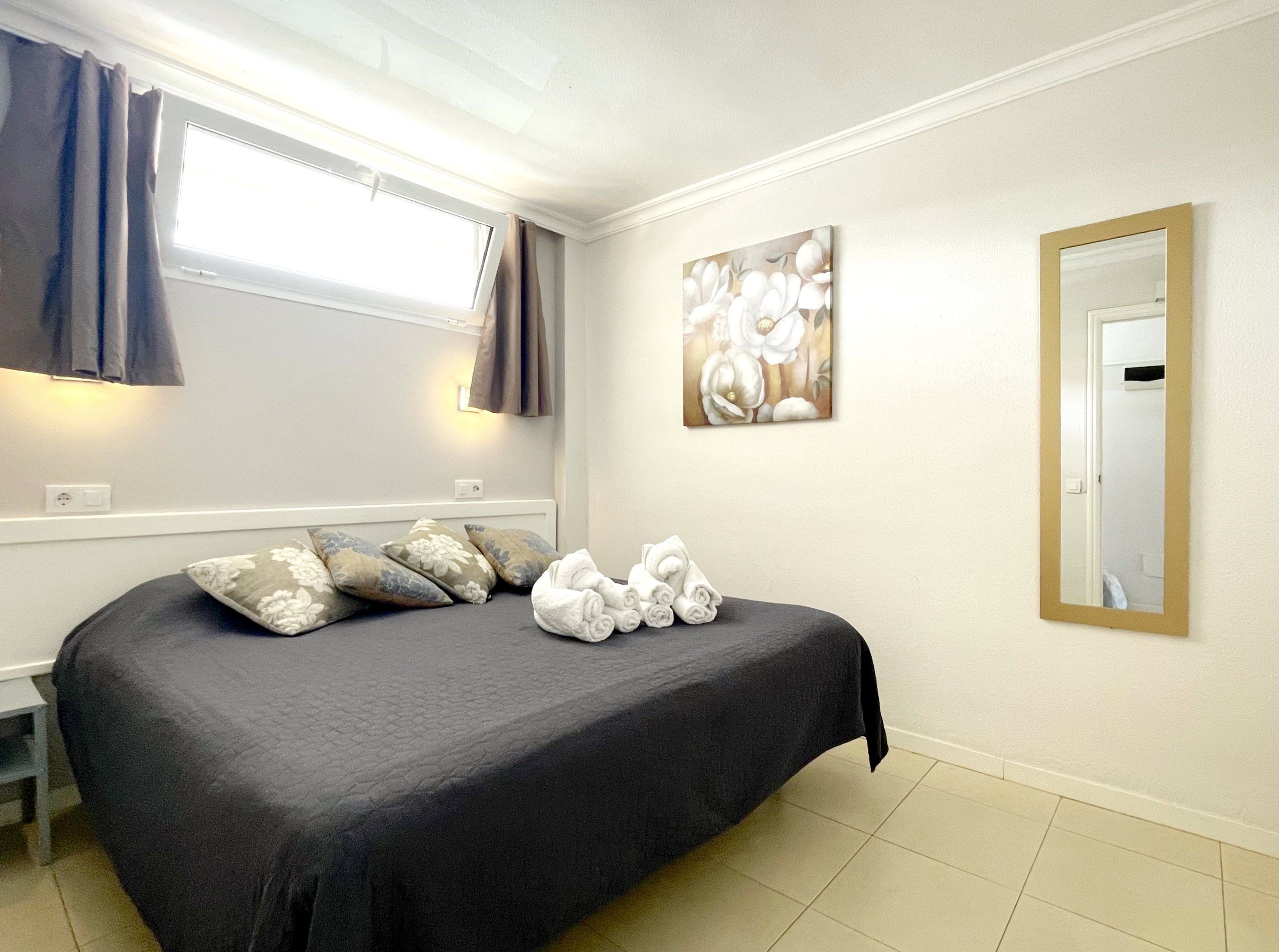 Bedroom with double bed and grey cover
