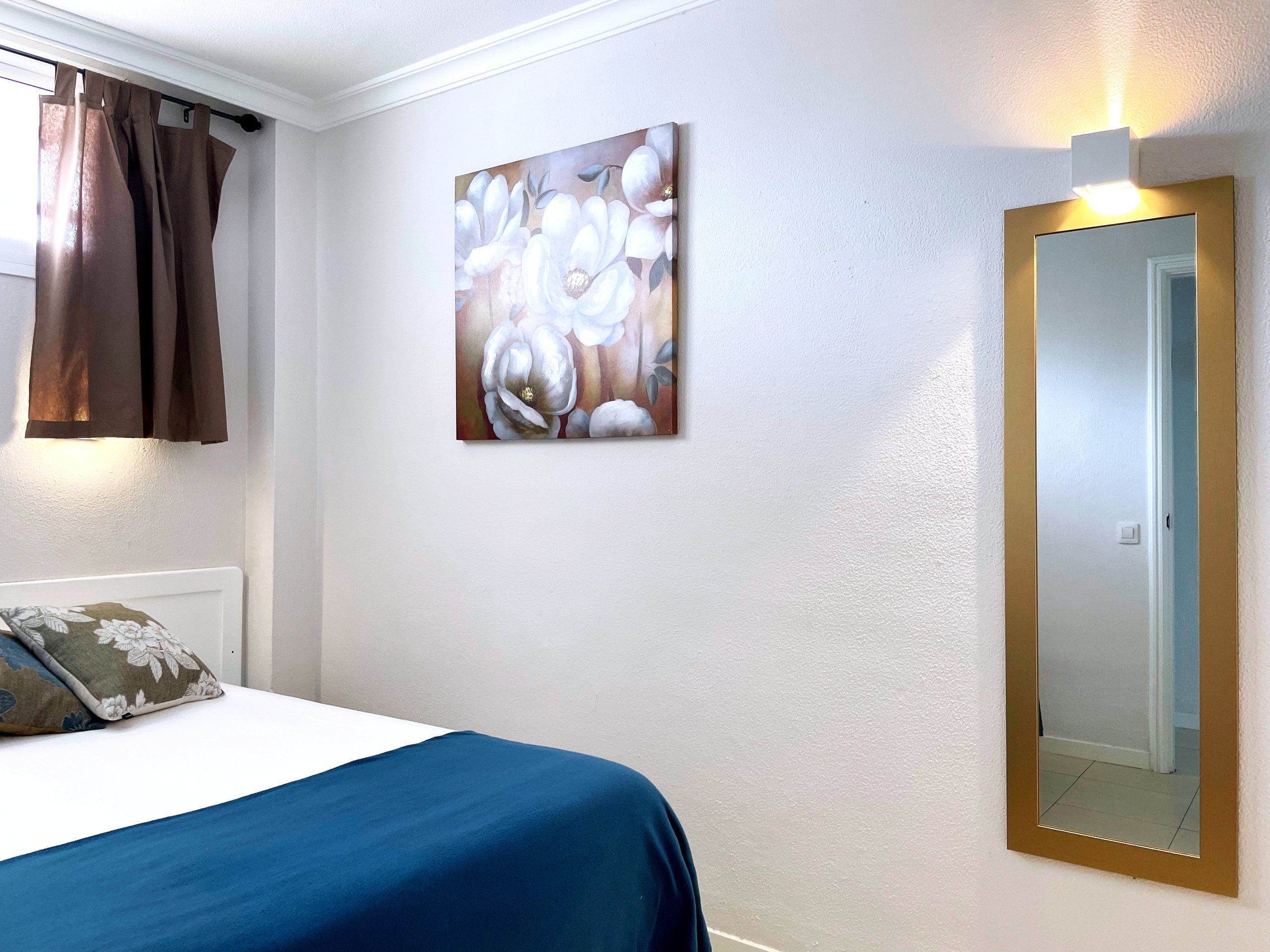 Bedroom with bed and mirror