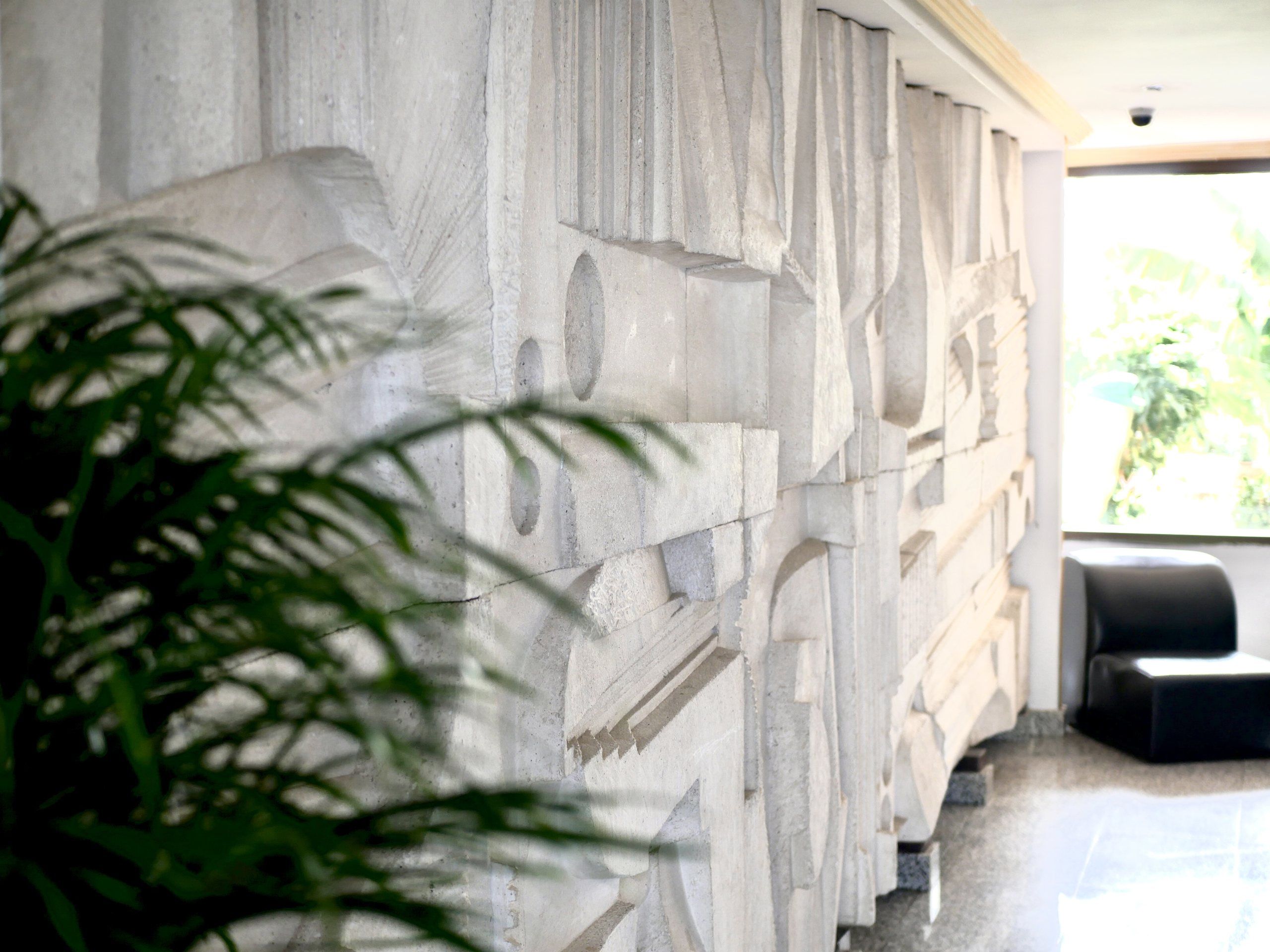Entrance lobby of the complex with a stone wall relief