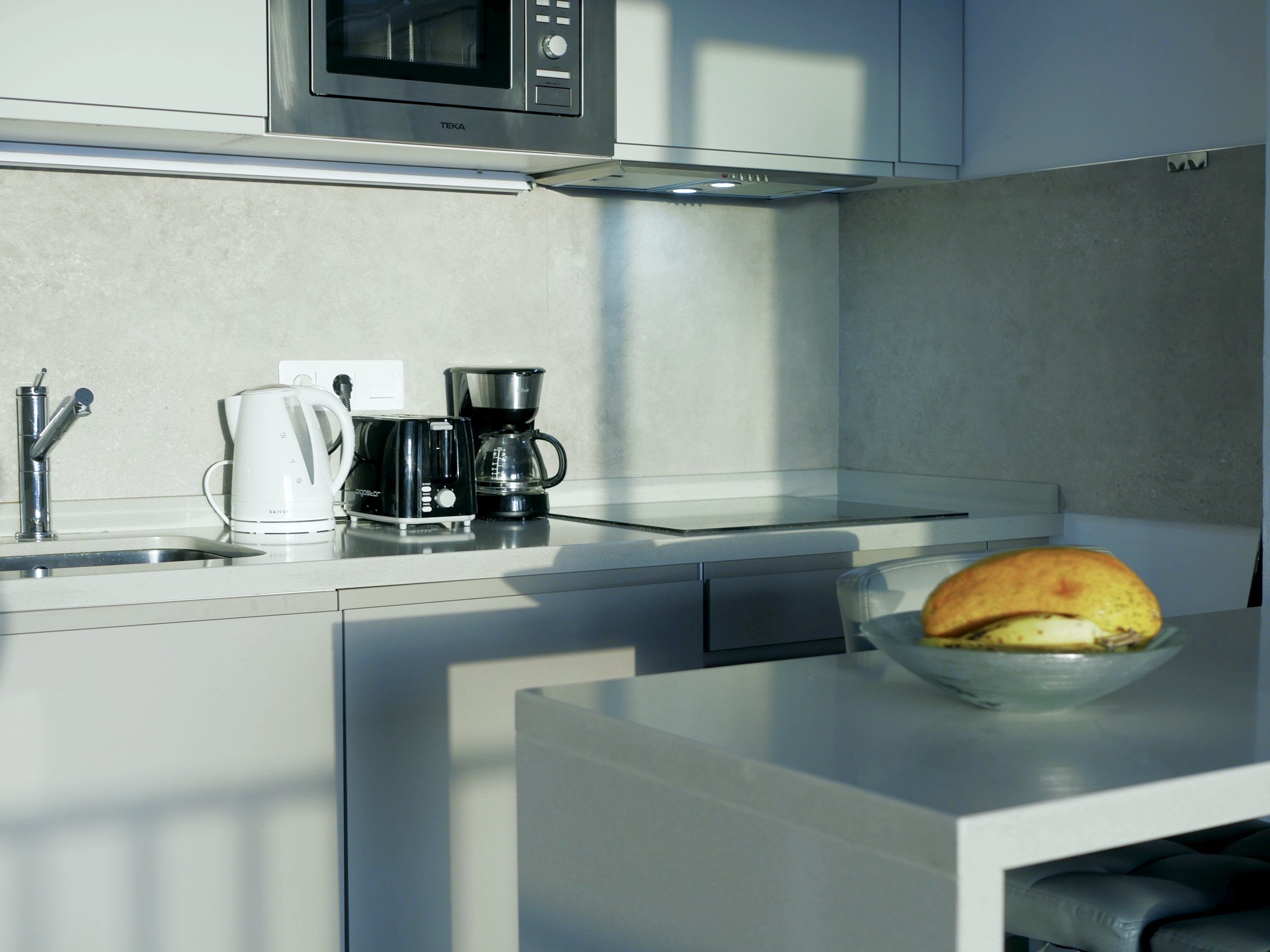Kettle and coffee maker on the kitchen counter