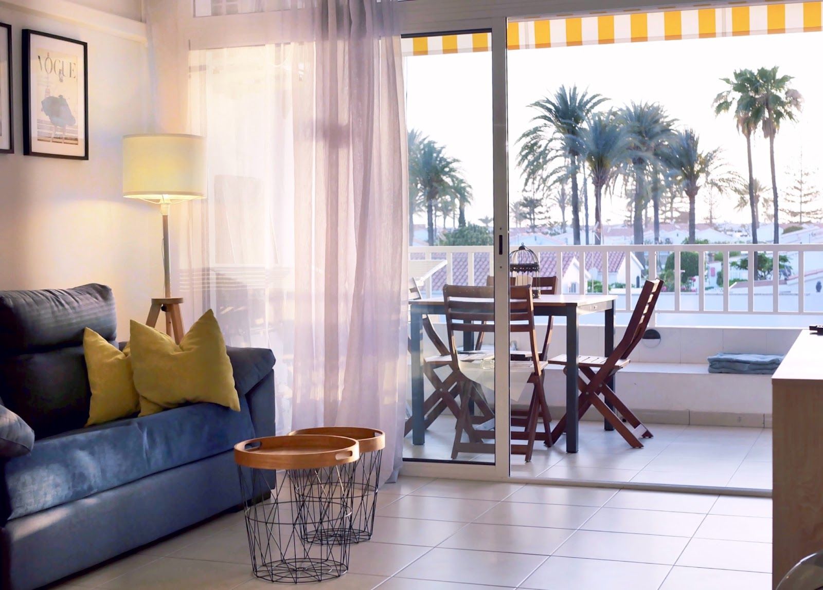 Blue sofa and dining table beside the loggia doors