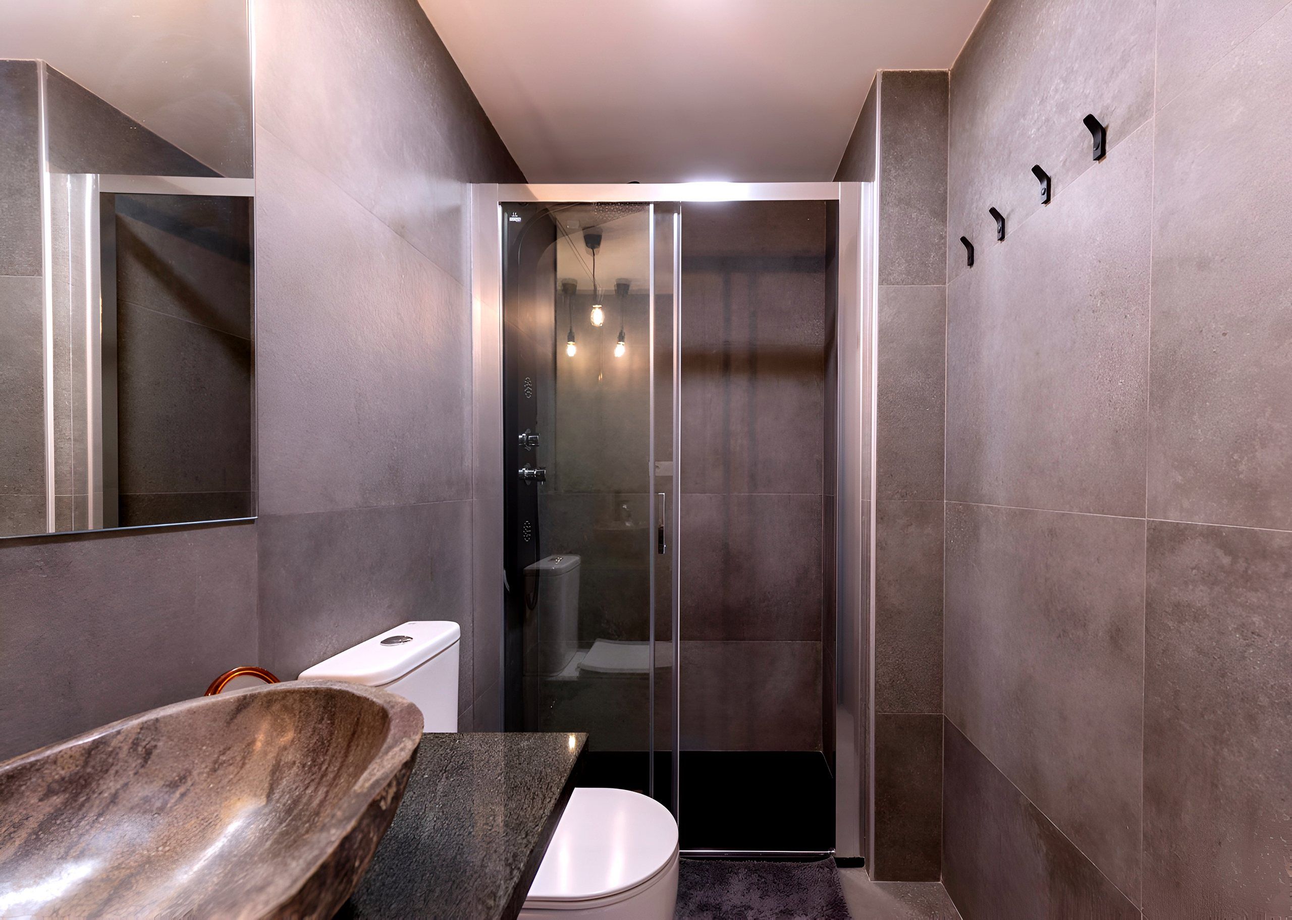 Bathroom with glass shower and stone basin