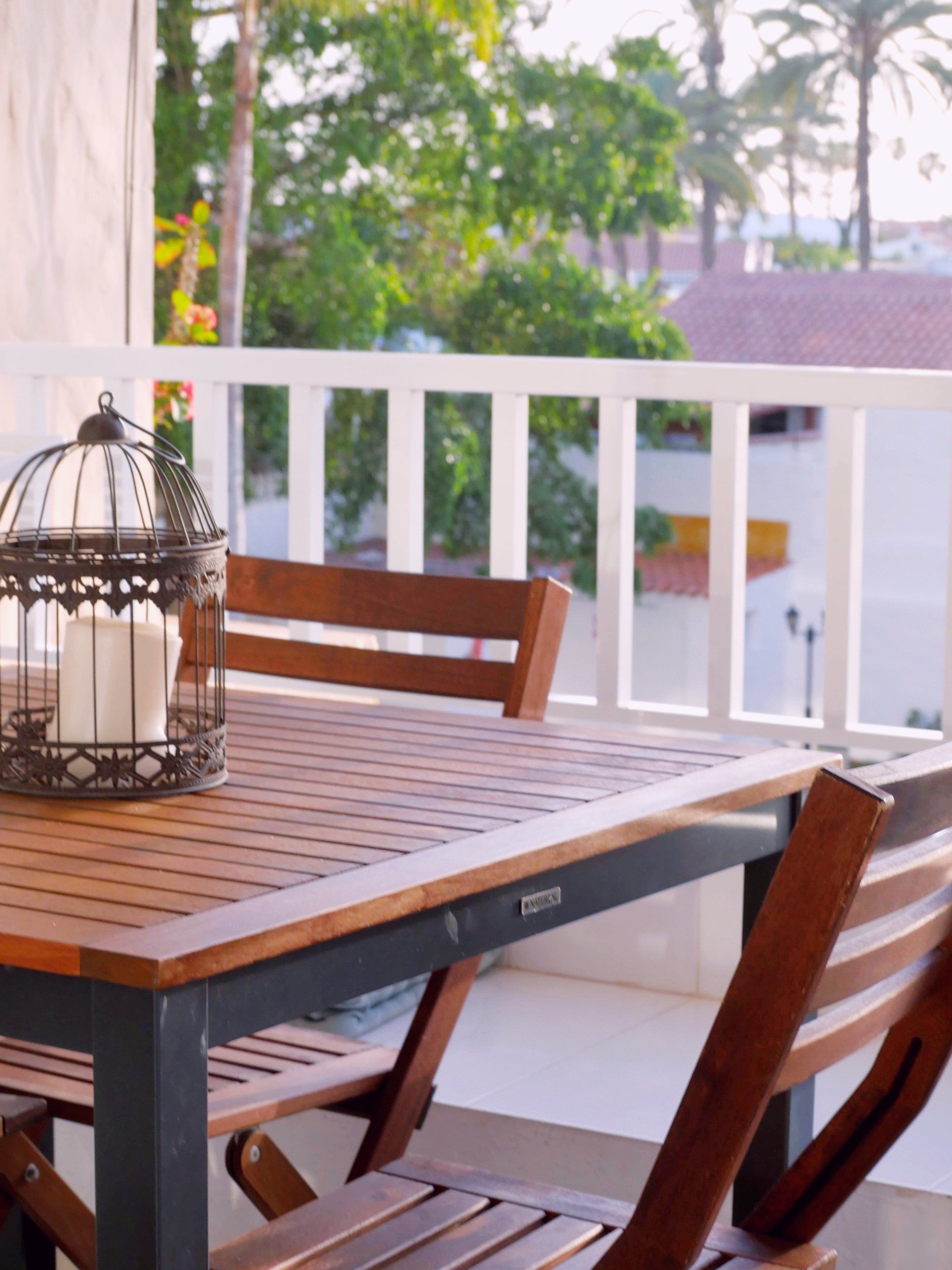 Loggia table with a lantern and chairs