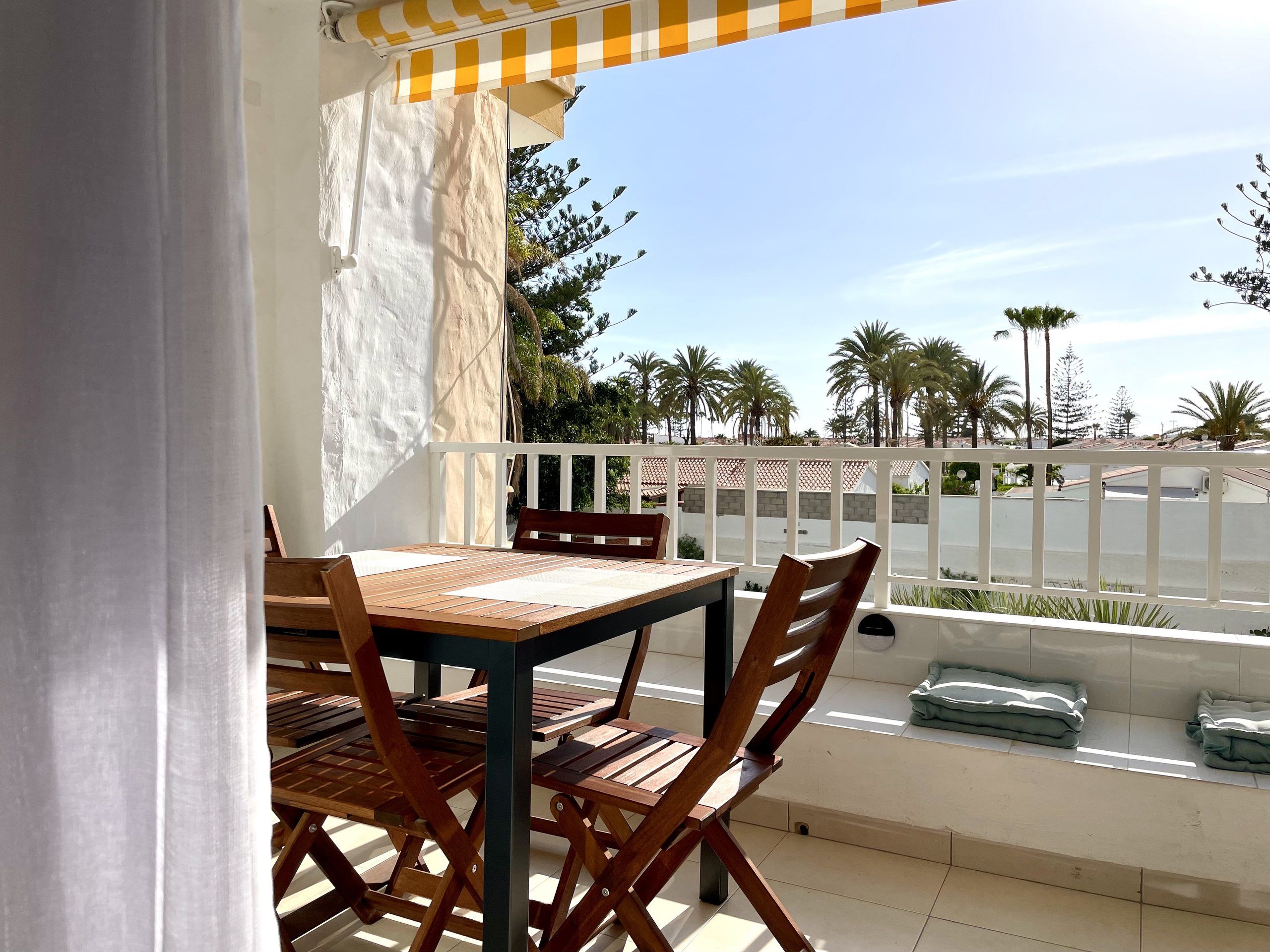 Loggia with table and chairs and a view of the garden